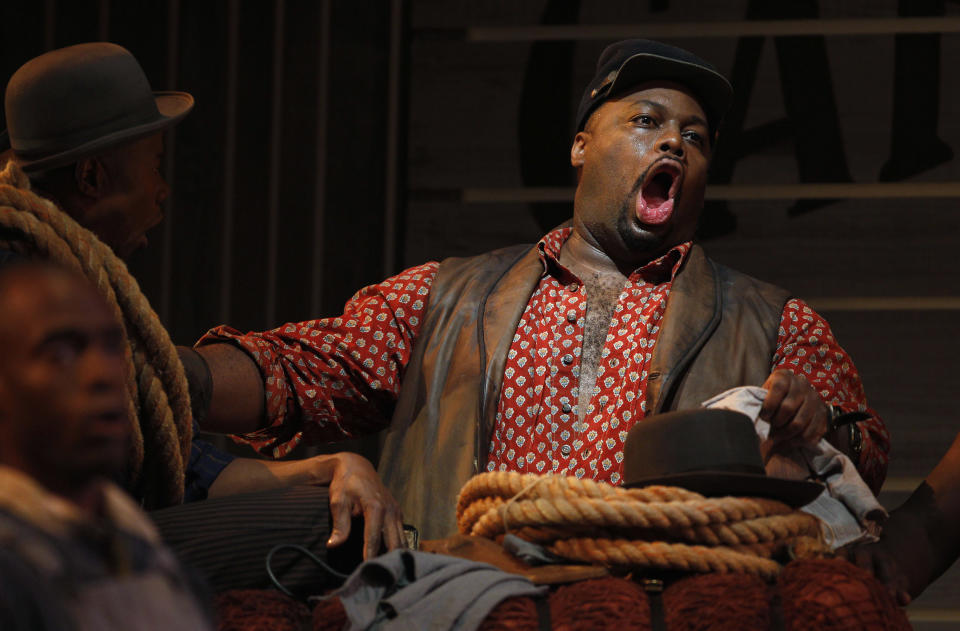 In this photo taken Feb. 9, 2012, Morris Robinson, right, portraying Joe, sings Ol' Man River at a dress rehearsal during the first act of the Lyric Opera of Chicago's production of "Show Boat." (AP Photo/M. Spencer Green)