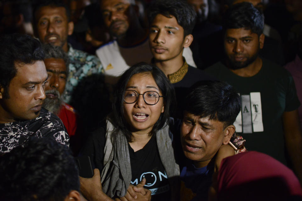 Family members of a person stuck at a commercial complex reacts as firefighters try to rescue them from a fire in Dhaka, Bangladesh, Thursday Feb. 29, 2024. Bangladesh's health minister says a fire in a six-story commercial complex in the nation's capital, Dhaka, has killed several people and injured dozens of others. (AP Photo/Mahmud Hossain Opu)