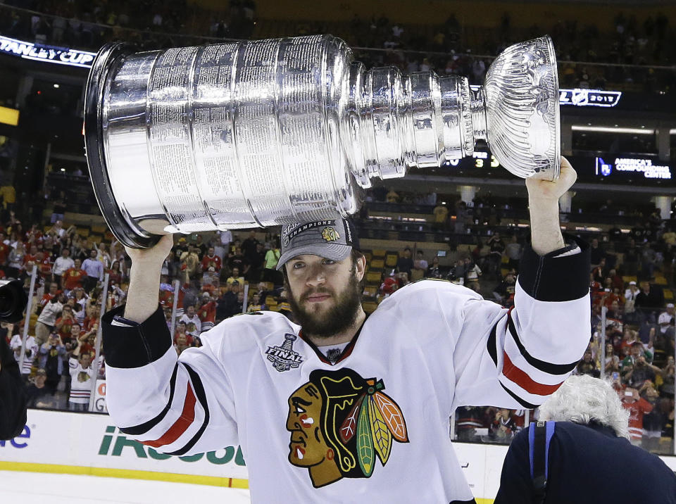 FILE - In this Monday, June 24, 2013, file photo, Chicago Blackhawks defenseman Brent Seabrook hoists the Stanley Cup after the Blackhawks beat the Boston Bruins 3-2 in Game 6 of the NHL hockey Stanley Cup Finals in Boston. Longtime Chicago Blackhawks defenseman and three-time Stanley Cup winner Brent Seabrook announced Friday, March 5, 2021, he’s unable to continue playing hockey because of injury. (AP Photo/Elise Amendola, File)