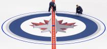 WINNIPEG, CANADA - JANUARY 8: Ice technicians install the Winnipeg Jets logo at centre ice at the MTS Centre on January 8, 2013 in Winnipeg, Manitoba, Canada. (Photo by Marianne Helm/Getty Images)