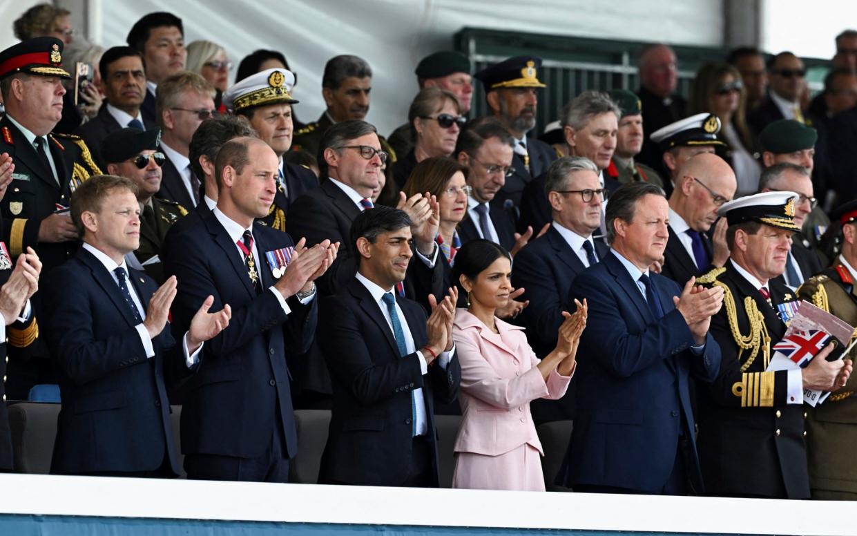 From left, Secretary of State for Defence Grant Shapps, Britain's Prince William, Britain's Prime Minister Rishi Sunak, his wife Akshaa Murty and British Foreign Secretary David Cameron applaud