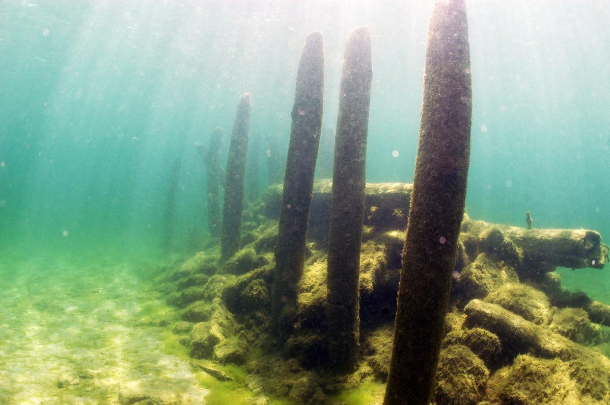 Remnants of an old pier break the water surface at Reynolds' Pier, which was built in 1869 in Jacksonport, Wisconsin. The remains of two shipwrecks are scattered around the site as well.