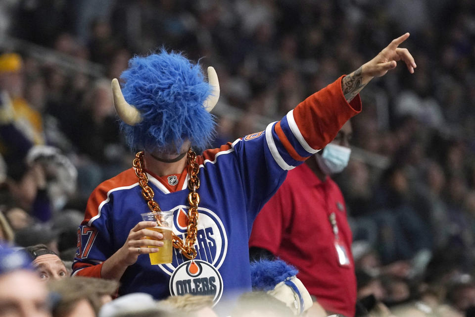 An Edmonton Oilers fan gestures during the third period in Game 3 of an NHL hockey Stanley Cup first-round playoff series against the Los Angeles Kings Friday, May 6, 2022, in Los Angeles. (AP Photo/Mark J. Terrill)