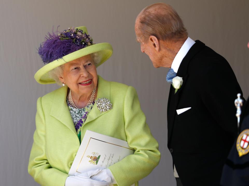 Queen Elizabeth II talks with Prince Philip, Duke of Edinburgh after the wedding of Prince Harry and Meghan Markle at St George's Chapel at Windsor Castle on May 19, 2018 in Windsor, England