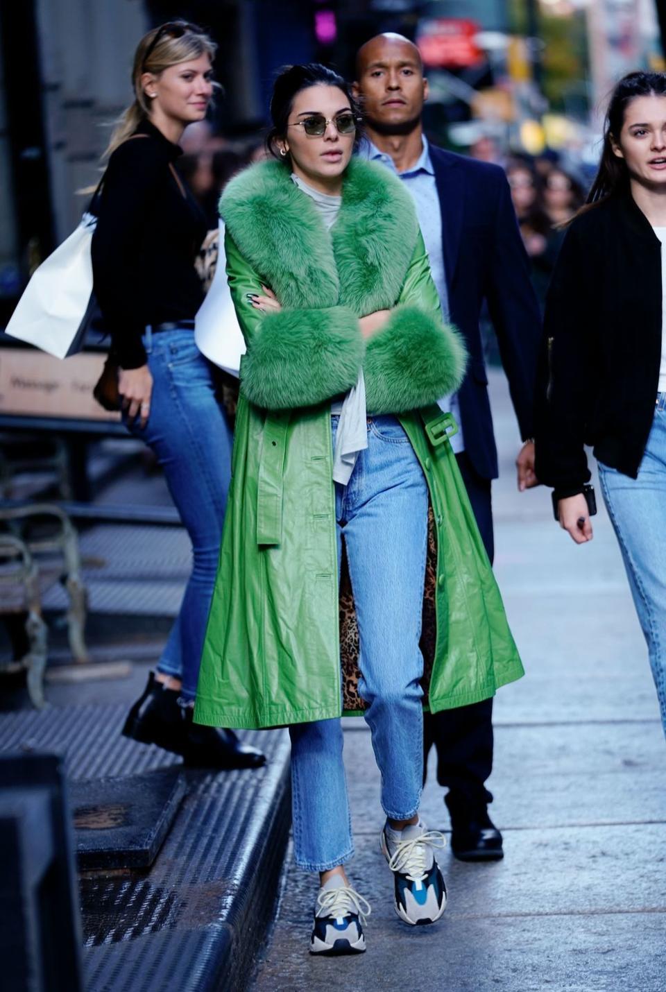 <p>For her 23rd birthday the reality star wore a green Saks Potts coats to cycle around New York, November 2018.</p>