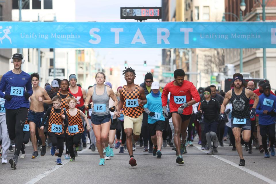 Runners take off from the starting line at the Race for Reconciliation's inaugural 5K Race in Downtown Memphis, Tenn. on Dr. Martin Luther King Jr. Day, Monday, January 17, 2022.