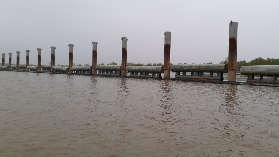 In this Thursday, Dec. 19, 2019 photo, newly built flood embankments stand near Bhasan Char, or floating island, in the Bay of Bengal, Bangladesh. The island in Bangladesh that was regularly submerged during monsoon seasons is ready to house 100,000 Rohingya refugees, but no date has been announced to begin relocating people from crowded and squalid camps on the country's border with Myanmar, officials said Thursday. The island is built to accommodate 100,000 people, just a fraction of the million Rohingya Muslims who have fled waves of violent persecution in their native Myanmar. (AP Photo/Saleh Noman) “Bhasan Char is ready for habitation. Everything has been put in place,” Bangladesh refugee, relief and repatriation commissioner Mahbub Alam Talukder told The Associated Press.