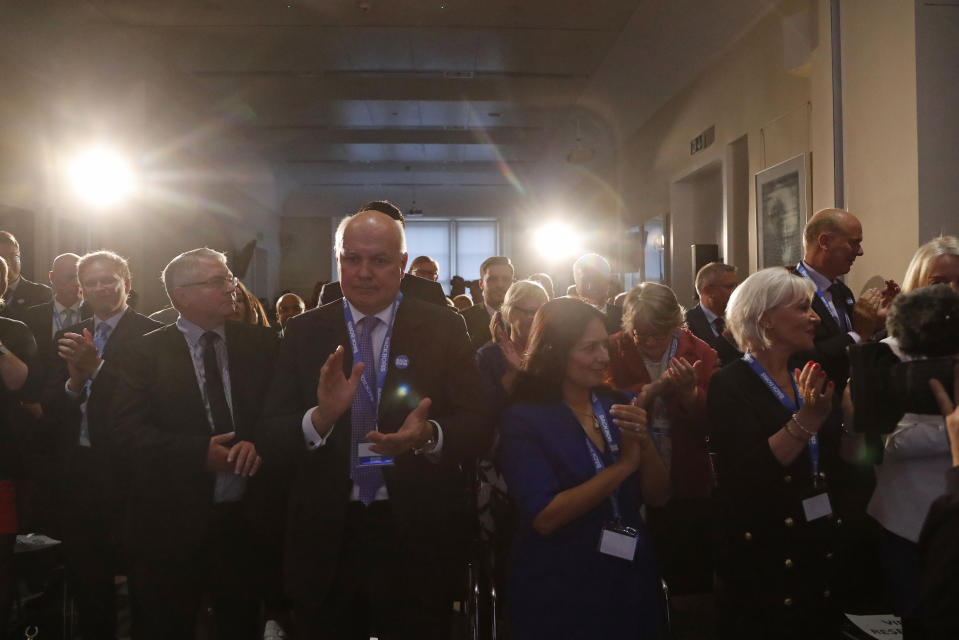 Supporters including, lawmakers Iain Duncan Smith, center left, and Priti Patel, center right, applaud after Britain's Conservative Party lawmaker Boris Johnson made the official launch of his leadership campaign, in London, Wednesday June 12, 2019. Boris Johnson solidified his front-runner status in the race to become Britain's next prime minister on Tuesday, gaining backing from leading pro-Brexit lawmakers.(AP Photo/Frank Augstein)