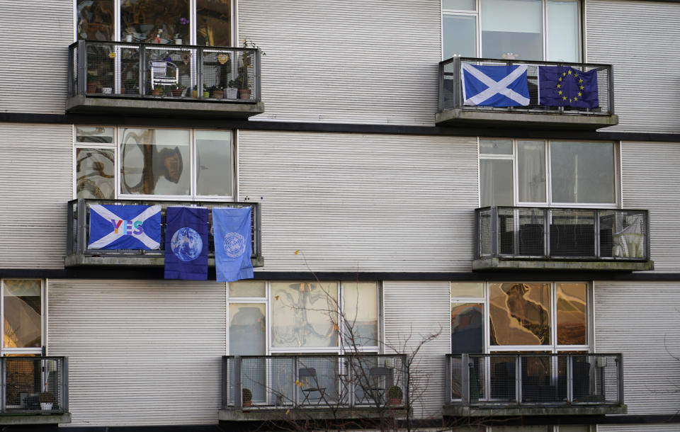Scottish, EU and UN flags hang from the balconies of flats near the COP26 U.N. Climate Summit in Glasgow, Scotland, Thursday, Nov. 4, 2021. The U.N. climate summit in Glasgow gathers leaders from around the world, in Scotland's biggest city, to lay out their vision for addressing the common challenge of global warming. (AP Photo/Alberto Pezzali)