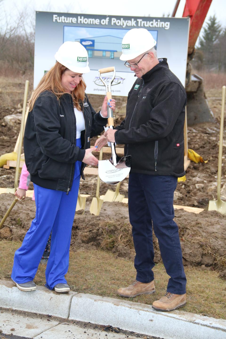 Pamela Polyak, owner of Polyak Trucking & Polyak Logistics, and Mike Moore, owner of Moore Construction Services, break ground for the new Polyak Trucking & Polyak Logistics building in the town of Lisbon.