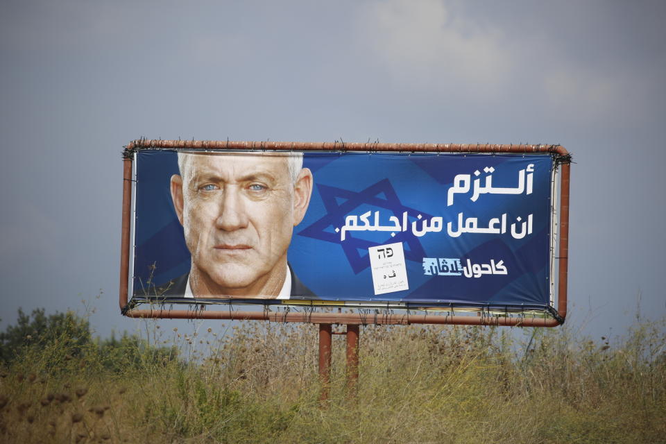 An election campaign billboard shows the Blue and White party leader Benny Gantz, in the Arab town of Baqa al-Gharbiyye, northern Israel, Monday, Sept. 16, 2019. The Arab writing says, " I commit to work for you." Israel will hold general elections on Tuesday. (AP Photo/Ariel Schalit)