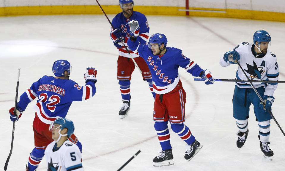 New York Rangers forward Artemi Panarin celebrates his third goal of the game with teammate Jonny Brodzinski during the third period of an NHL hockey game against the San Jose Sharks, Sunday, Dec. 3, 2023, in New York. (AP Photo/John Munson)