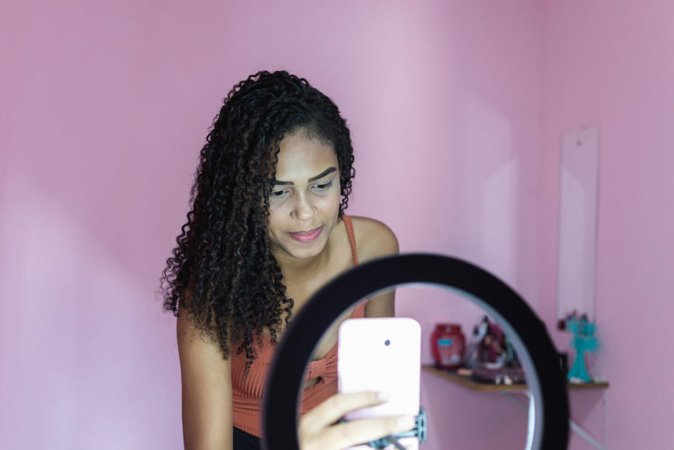 Woman using tiktok on phone. (Getty Images)