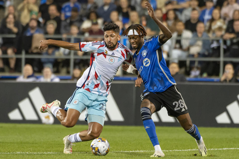 Chicago Fire's Mauricio Pineda (22) and CF Montreal's Jules-Anthony Vilsaint (28) battle for the ball during the first half of an MLS soccer game in Montreal, Saturday, Sept. 16, 2023. (Peter McCabe/The Canadian Press via AP)