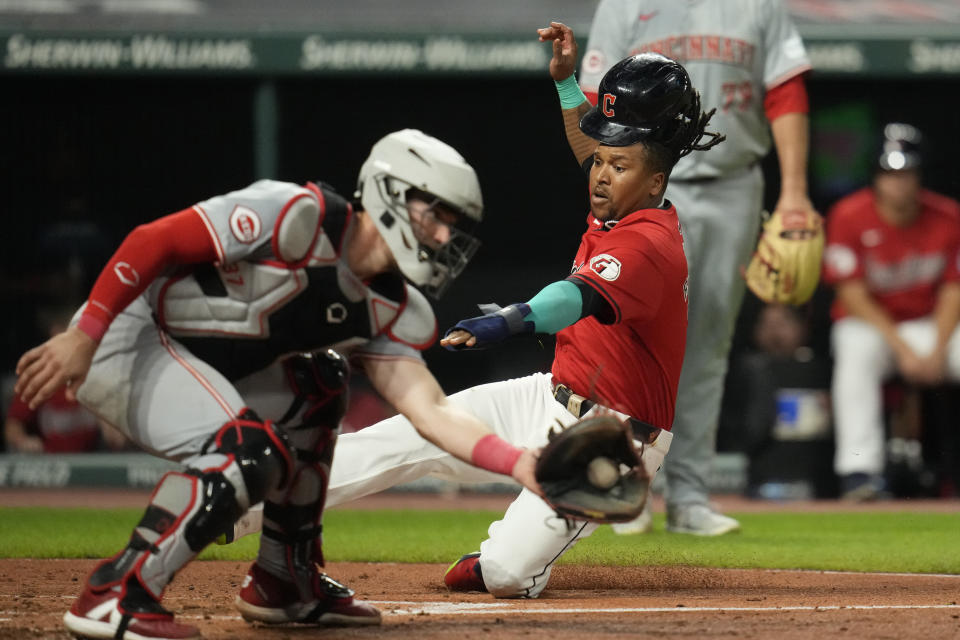 Cleveland Guardians' Jose Ramirez, right, starts his slide into home plate as Cincinnati Reds catcher Tyler Stephenson takes the throw in the fifth inning of a baseball game in Cleveland, Tuesday, Sept. 24, 2024. (AP Photo/Sue Ogrocki)