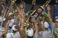 Hawaii team members hold the trophy after Hawaii defeated BYU in the final of the NCAA men's volleyball tournament Saturday, May 8, 2021, in Columbus, Ohio. (AP Photo/David Dermer)