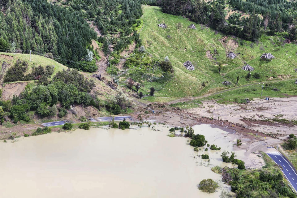 In this image released by the New Zealand Defense Force on Wednesday, Feb. 15, 2023, a road between Napier and Wairoa is washed out by flood water. The New Zealand government declared a national state of emergency Tuesday after Cyclone Gabrielle battered the country's north in what officials described as the nation's most severe weather event in years. (New Zealand Defense Force via AP)