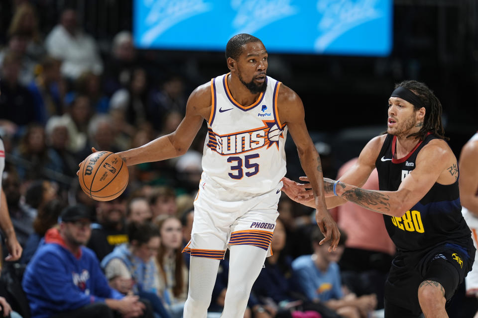Phoenix Suns forward Kevin Durant is defended by Denver Nuggets forward Aaron Gordon during the second half of an NBA basketball game Wednesday, March 27, 2024, in Denver. (AP Photo/David Zalubowski)