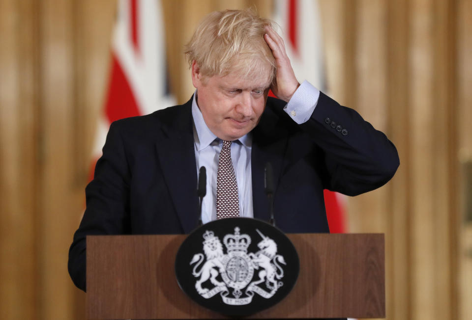 FILE - In this Tuesday, March 3, 2020 file photo, Britain's Prime Minister Boris Johnson reacts during a press conference at Downing Street on the government's coronavirus action plan in London. British Prime Minister Boris Johnson is expected to confirm Monday June 14, 2021, that the next planned relaxation of coronavirus restrictions in England will be delayed as a result of the spread of the delta variant first identified in India. (AP Photo/Frank Augstein, Pool, File)