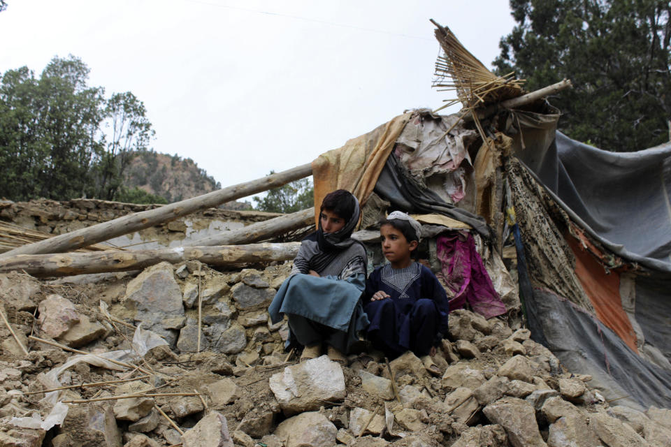 Afghan boys sit amid the rubble of their house, which was destroyed by an earthquake, in the Spera District of Khost Province, Afghanistan, June 22, 2022. / Credit: AP