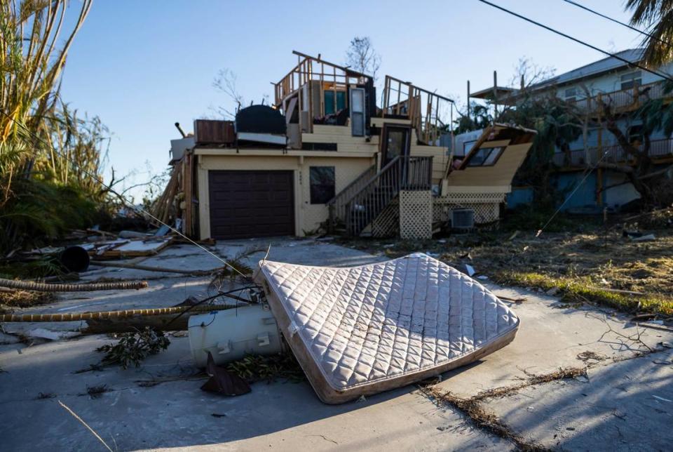 A mattress lies on top of an electrical transformer near a home on the southern tip of St. James City on Friday, Sept. 30, 2022, in Pine Island, Fla. Hurricane Ian made landfall on the coast of Southwest Florida as a Category 4 storm two days earlier.