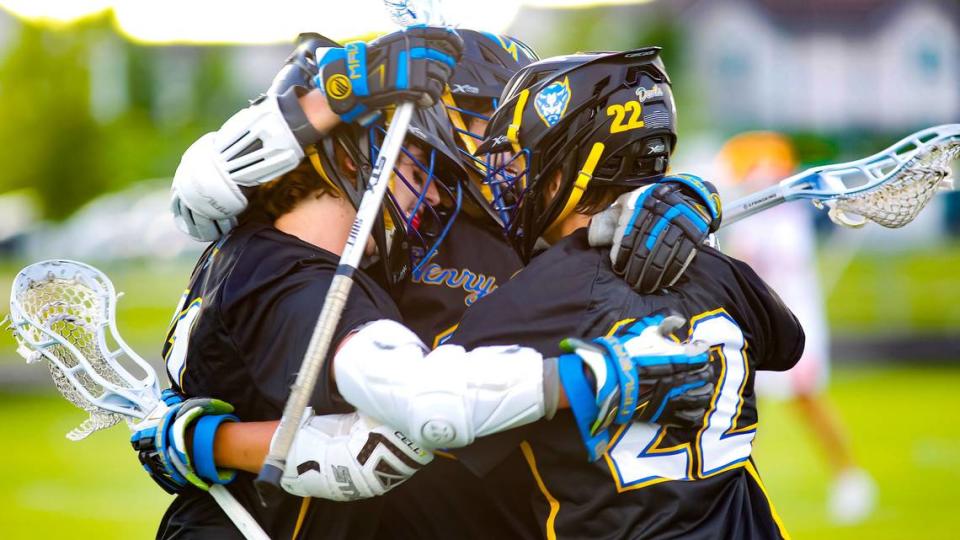 Henry Clay’s Jonah Brooking, left, was congratulated by teammates, Grady Browne, center, and Max Thayer, after scoring a tying goal in the fourth quarter against Frederick Douglass in the Commonwealth Lacrosse League Region 2 championship at The Farm on Wednesday.