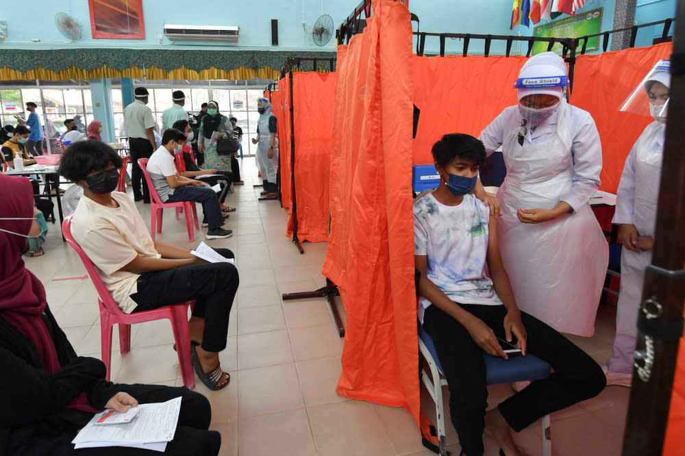 A health officer administers the Pfizer-BioNTech Covid-19 vaccine to a student at Sekolah Menengah Kebangsaan Sultan Sulaiman in Kuala Terengganu, September 21, 2021. — Bernama pic