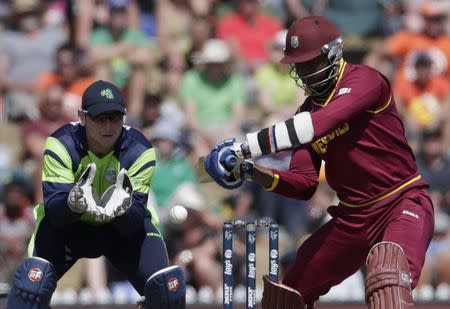 West Indies' Marlon Samuels (R) plays a shot as he is watched by Ireland's Kevin O'Brien during their Cricket World Cup match in Nelson, February 16, 2015. REUTERS/Anthony Phelps