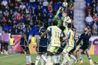 Vancouver Whitecaps goalkeeper Yohei Takaoka (1), top left, punches the ball away during an MLS soccer match against the New York Red Bulls, Saturday, April 27, 2024, in Harrison, N.J. (AP Photo/Stefan Jeremiah)