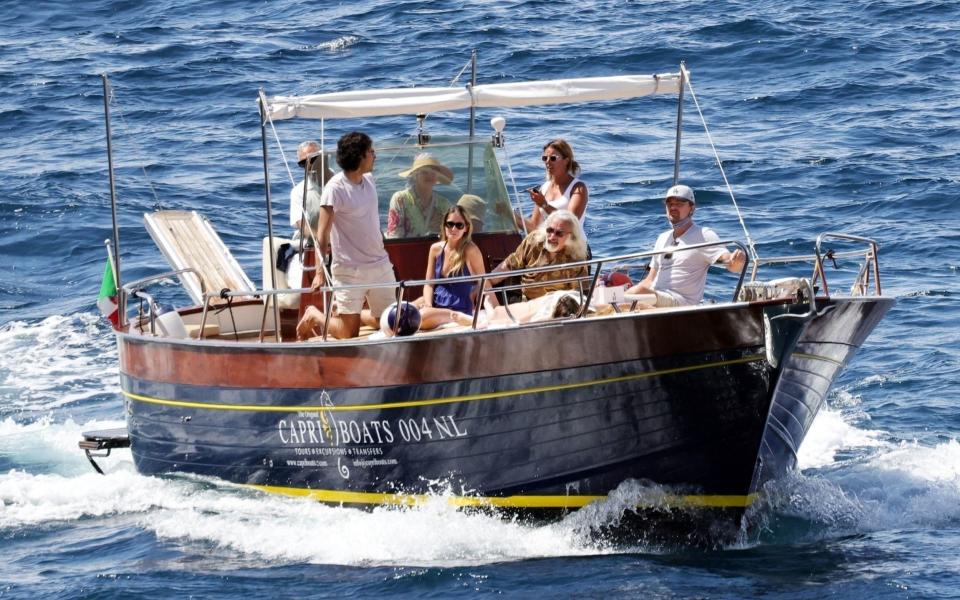 Leonardo DiCaprio (right) pictured on a boat with his father George, niece Normandie DiCaprio and stepmother Peggy Farrar