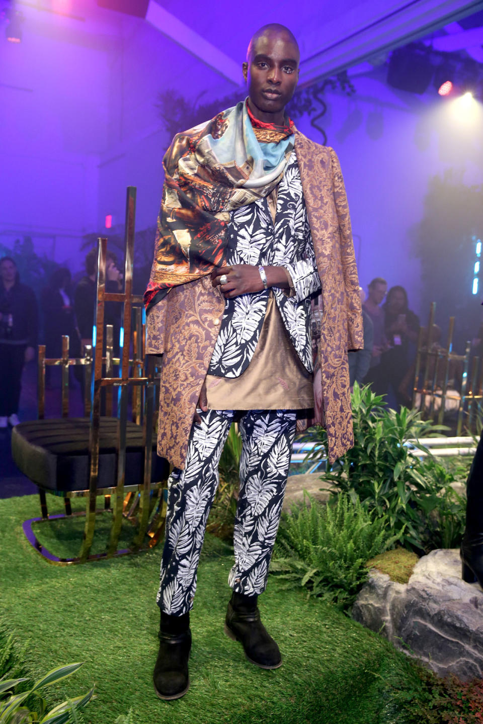 <p>Model wears a maximalist style print suit, coat and scarf design by Ikré Jones at the Black Panther Welcome to Wakanda NYFW fashion presentation. (Photo: Courtesy of Marvel Studios Black Panther/Getty) </p>