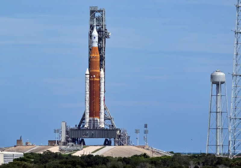NASA's Space Launch System (SLS) with the Orion crew capsule perched on top, stands on launch pad 39B one day after an engine-cooling problem forced NASA to delay the debut test launch