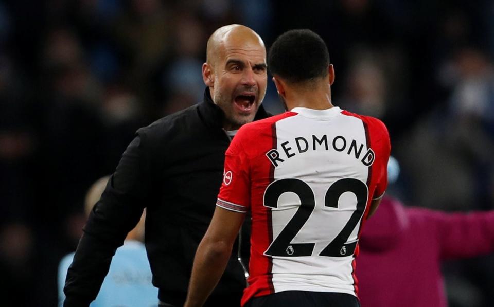 Manchester City manager Pep Guardiola talks to Southampton's Nathan Redmond - REUTERS