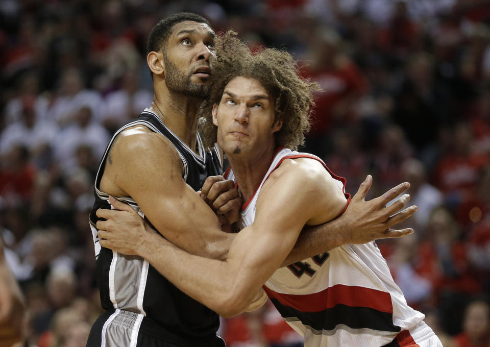 Portland Trail Blazers' Robin Lopez, right, and San Antonio Spurs' Tim Duncan, left, battle under the boards in the second half during Game 3 of a Western Conference semifinal NBA basketball playoff series Saturday, May 10, 2014, in Portland, Ore. The Spurs won 118-103. (AP Photo/Rick Bowmer)