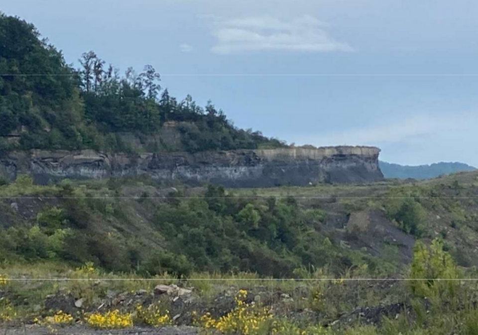 Companies affiliated with West Virginia Gov. Jim Justice had not properly reclaimed several Eastern Kentucky coal mines. This photo shows a highwall, or cliff, the state said was not reclaimed as required.