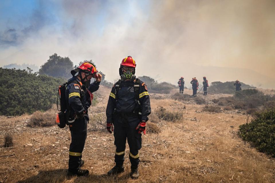 Greek firefighters work to extinguish wildfires near Vati (AFP via Getty Images)
