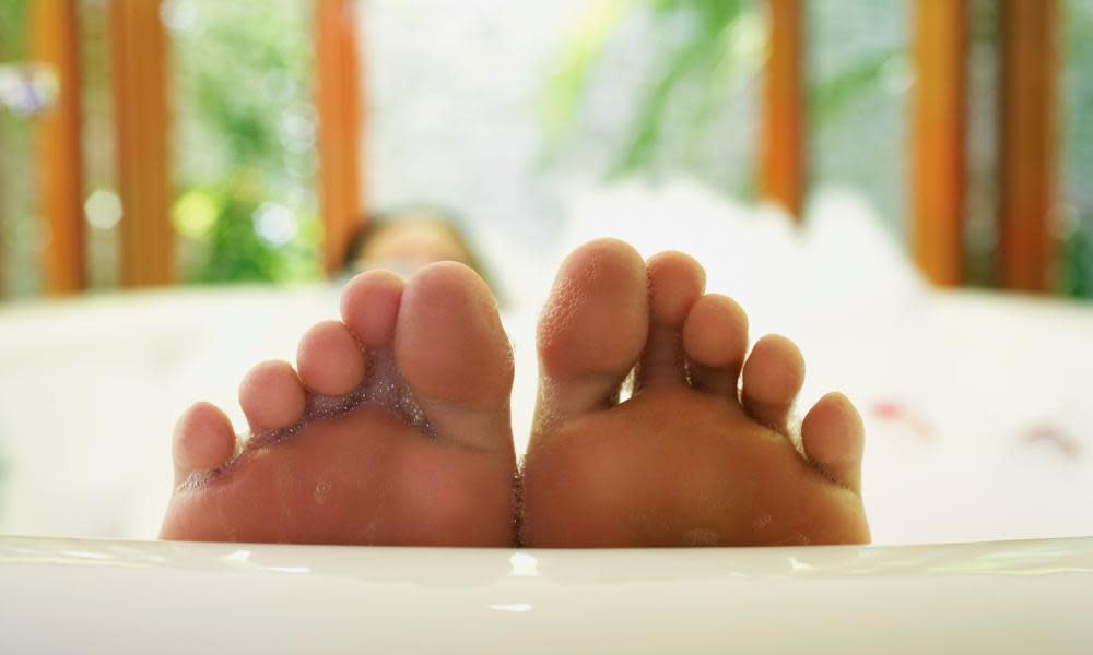 Close up of woman’s feet in bubble bath