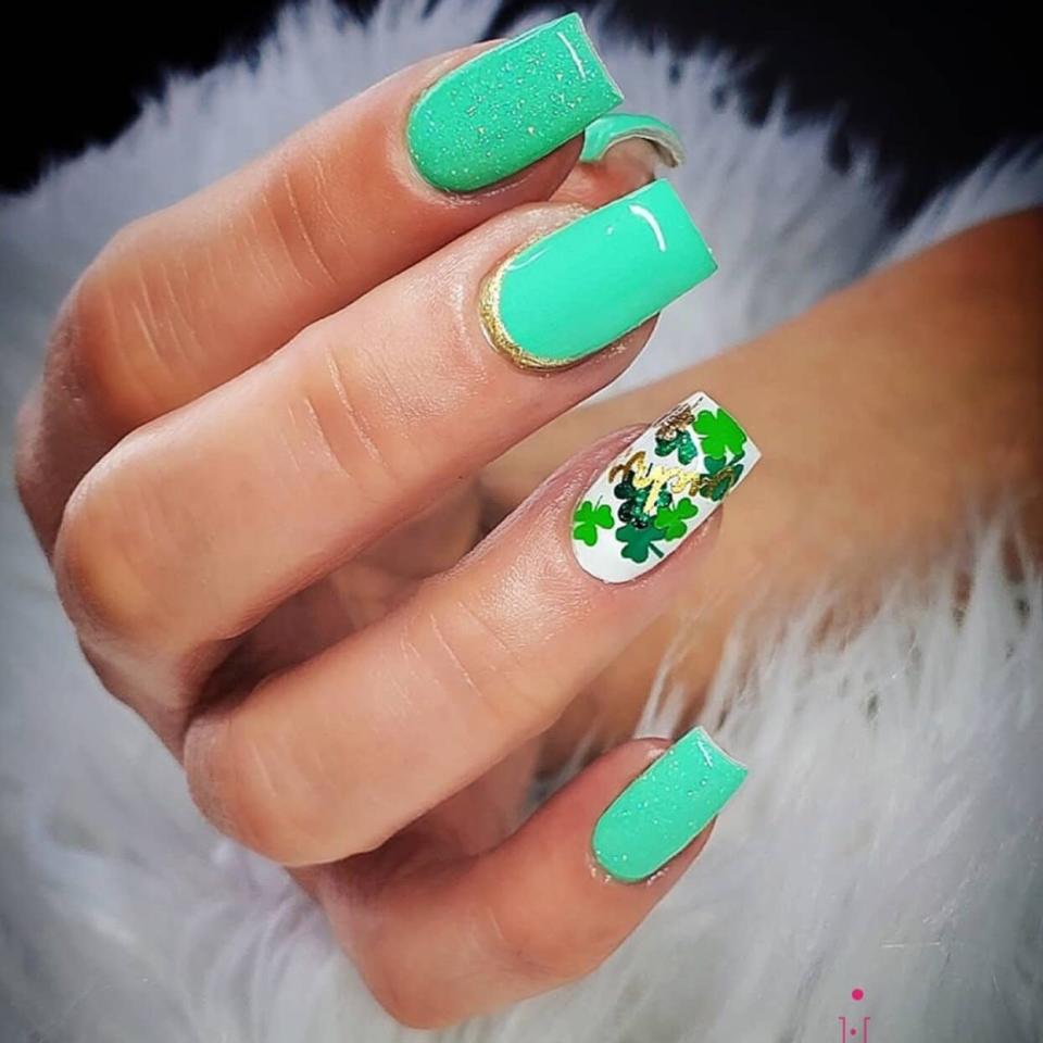 Hand with four leaf clover nail art