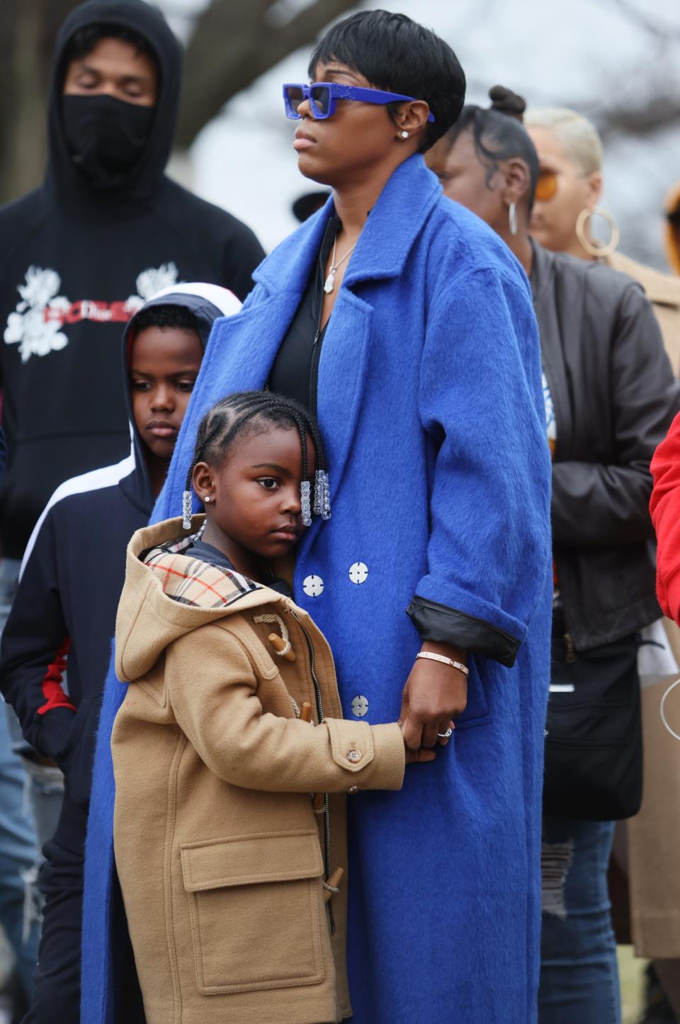 Mia Jaye, partner of Young Dolph, embraces their children Aria and Tré during a ceremony to rename a stretch of street along Dunn Avenue in honor of the late rapper on Wednesday, Dec. 15, 2021.