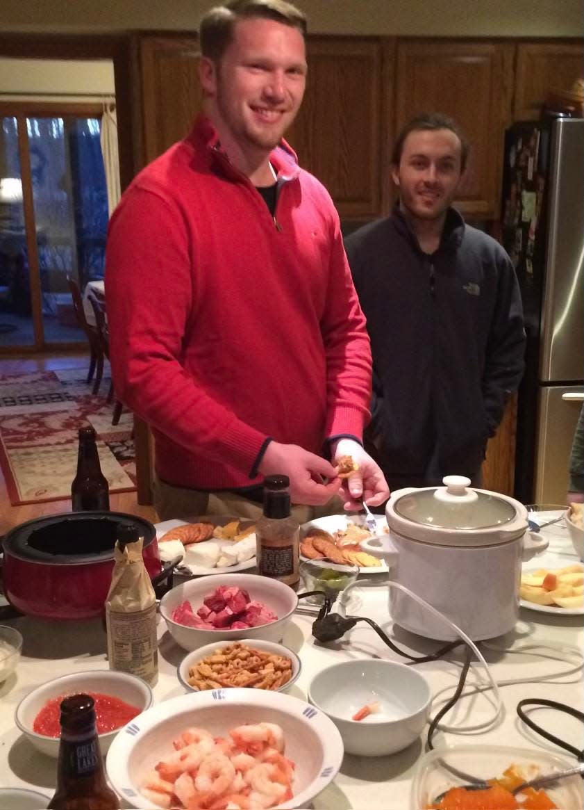 Zachary Wison and his cousin, Nathan Breitsch, shown in a 2016 photo from a family dinner. Wilson, 26, died in his sleep in March 2021 in Chicago.