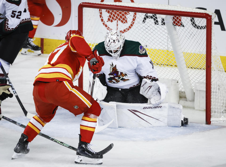 Arizona Coyotes goalie Connor Ingram (39) is unable to stop Calgary Flames forward Connor Zary (47) from scoring the second period of an NHL hockey game in Calgary, Alberta, Sunday, April 14, 2024. (Jeff McIntosh/The Canadian Press via AP)