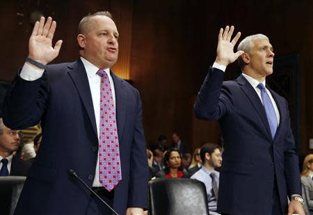 Chief Financial Officer and executive vice president of Target John Mulligan (L) and Chief Information Officer at Neiman Marcus Michael Kingston swear in before testifying at the Senate Judiciary Committee hearing about Privacy in the Digital Age on Capitol Hill in Washington, February 4, 2014. REUTERS/Larry Downing