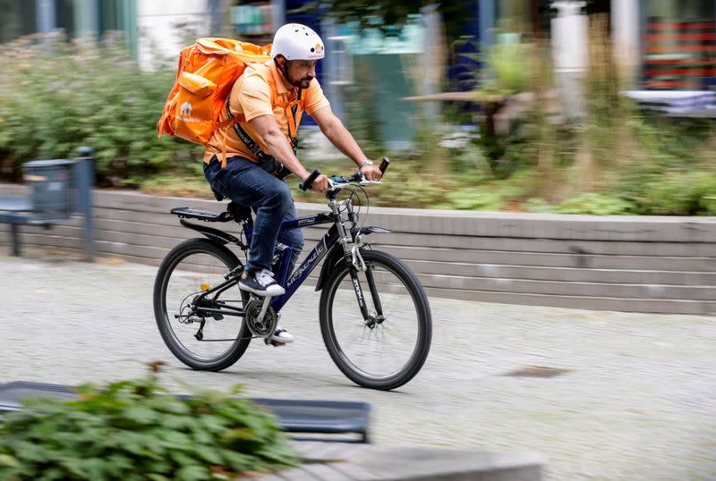 Former Afghan Communication Minister Sadaat works as a bicycle rider for the food delivery service Lieferando in Leipzig