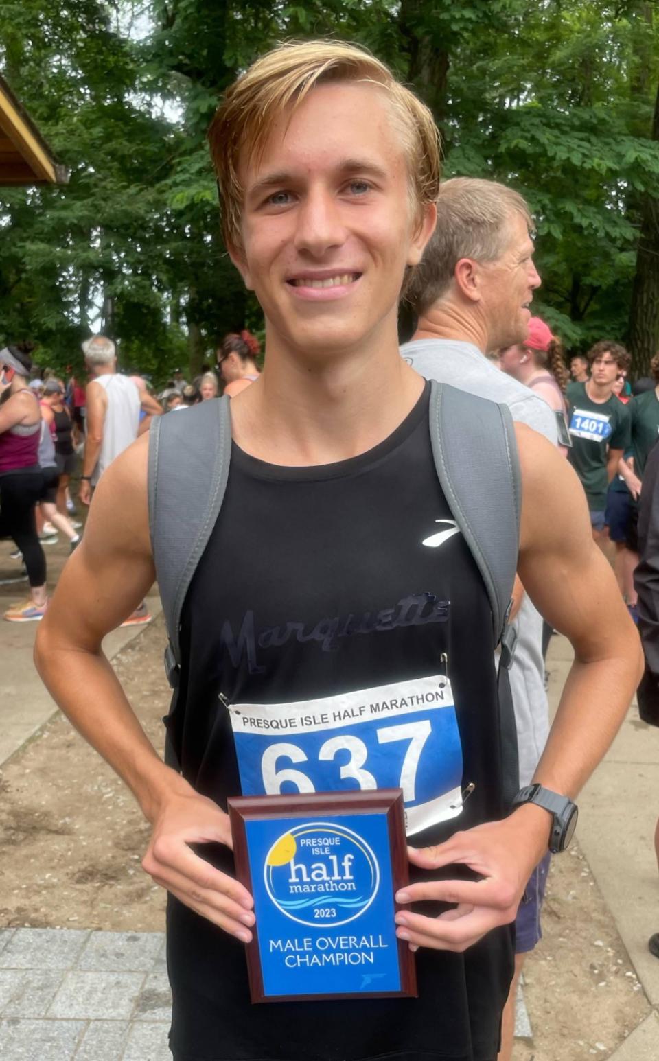 Dylan Throop, a 2021 General McLane graduate and 2019 PIAA cross country gold medalist, poses with the trophy he received for winning Sunday's Presque Isle Half Marathon. Throop completed the 13.1-mile course in 1 hour, 7 minutes, 37.85 seconds.