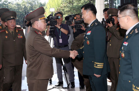 North Korean Lieutenant General An Ik San is greeted by South Korean Major General Kim Do-gyun before a meeting at the Peace House of the border village of Panmunjom, South Korea, July 31, 2018. Yonhap via REUTERS