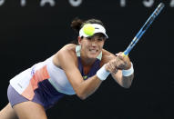 Spain's Garbine Muguruza makes a backhand return to Ukraine's Elina Svitolina during their third round singles match at the Australian Open tennis championship in Melbourne, Australia, Saturday, Jan. 25, 2020. (AP Photo/Dita Alangkara)