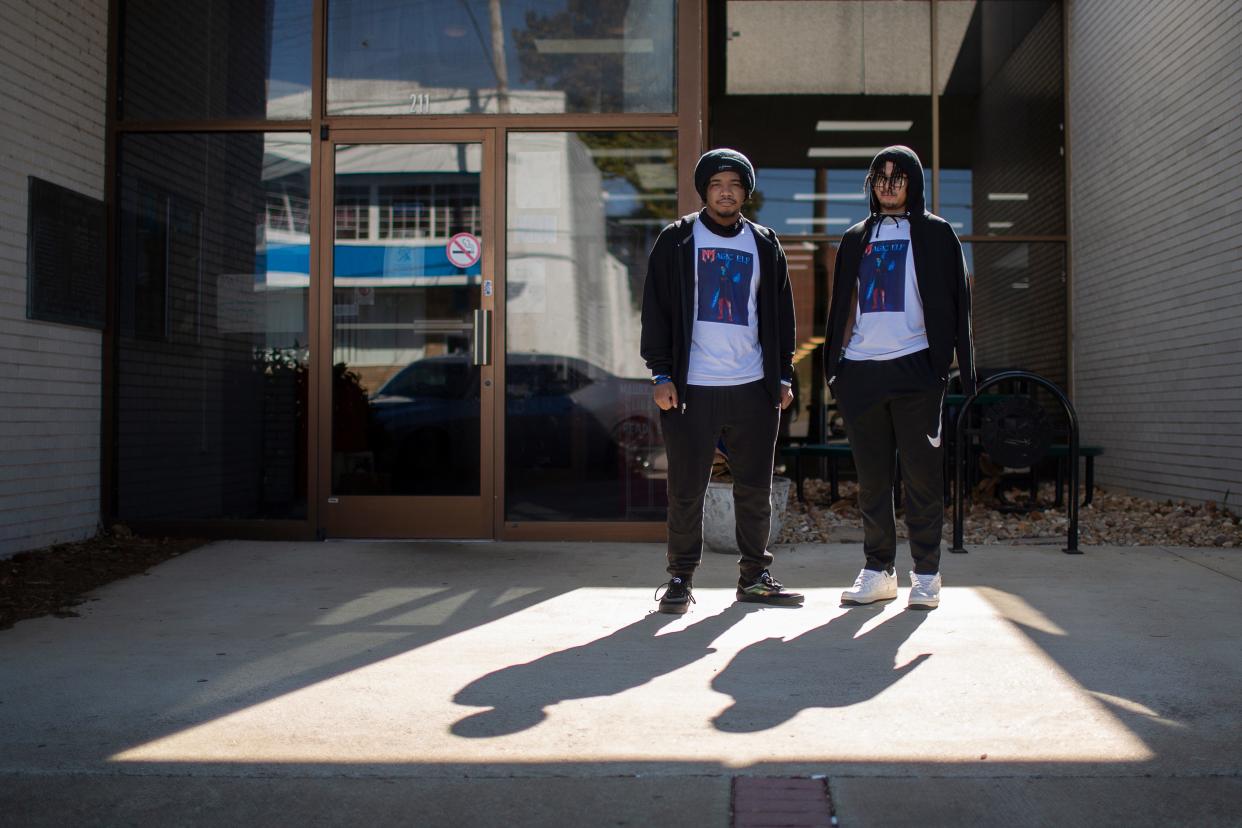 The young creators of the graphic novel “Nightman,” Kanye Conway and Ryon Conway stand in front of the Maury County Library in Columbia, Tenn., on Saturday, Feb. 19, 2022. 