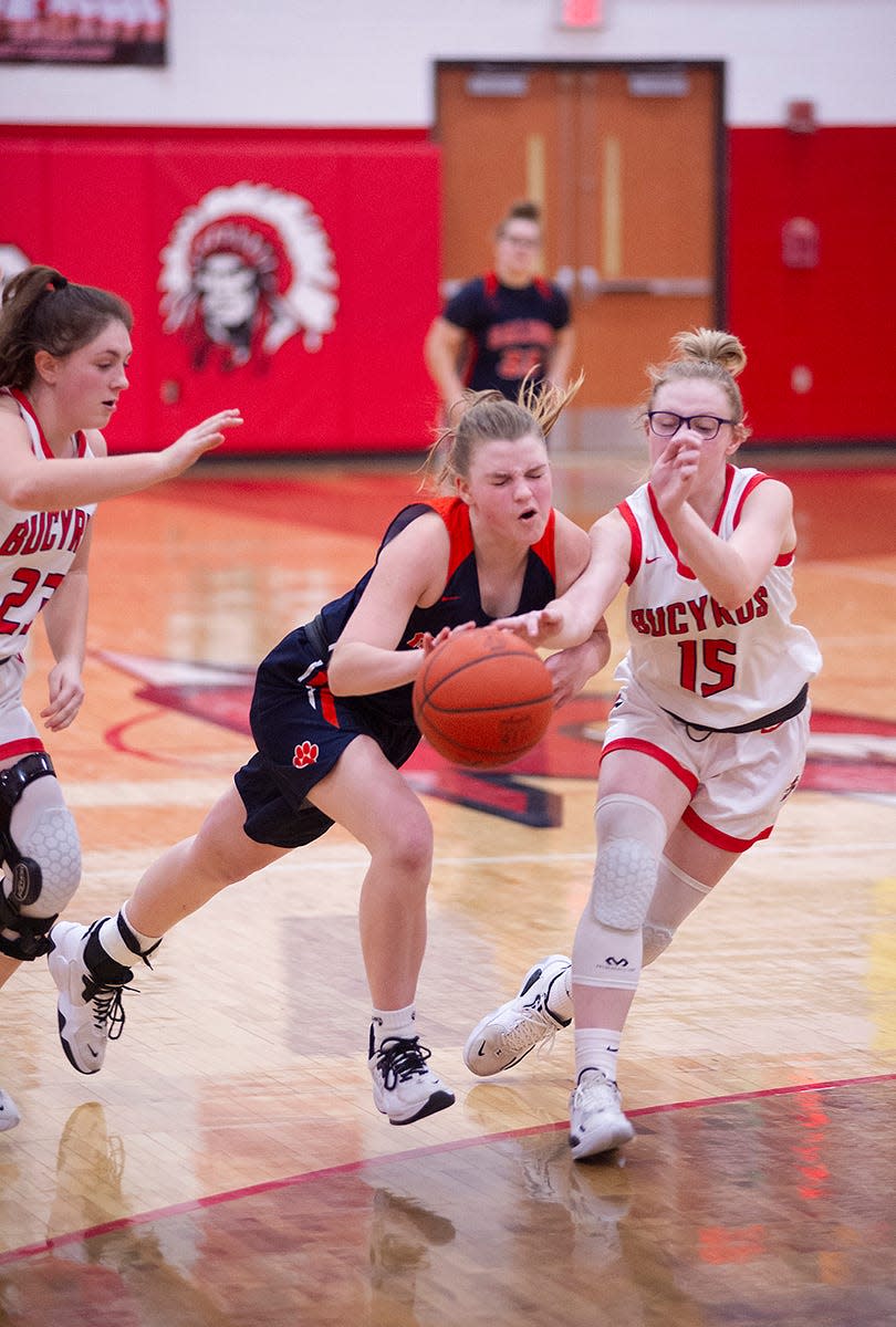 Galion's Cameron Eckert struggles to keep the ball away from Bucyrus' Marissa Middleton.