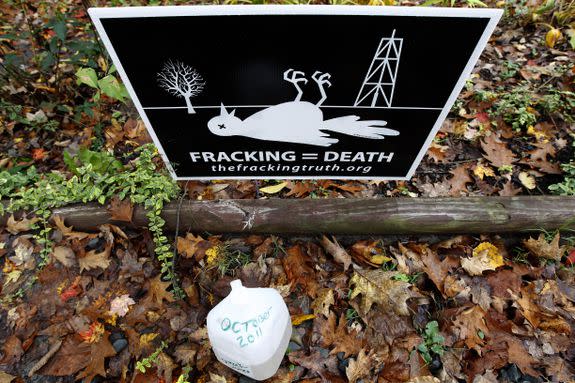 A sign and a jug of water from a private well sit outside a home in Dimock, Pennsylvania, where state regulators in 2011 blamed faulty gas wells for leaking methane into the groundwater.