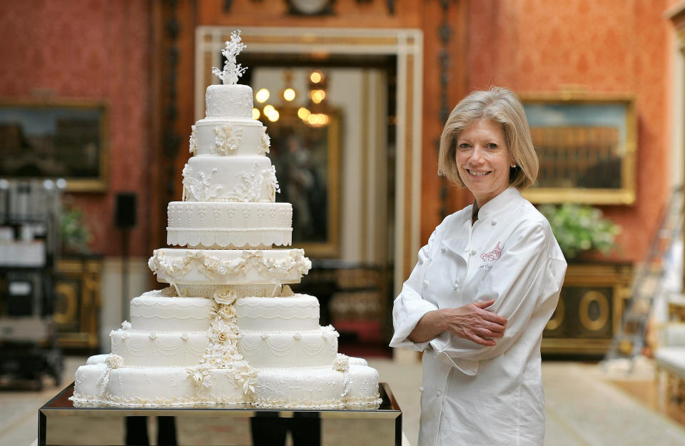 Fiona Cairns stands proudly next to the Royal Wedding cake that she and her team made for Prince William and Kate Middleton, in the Picture Gallery of Buckingham Palace in central London, today.   (Photo by John Stillwell/PA Images via Getty Images)